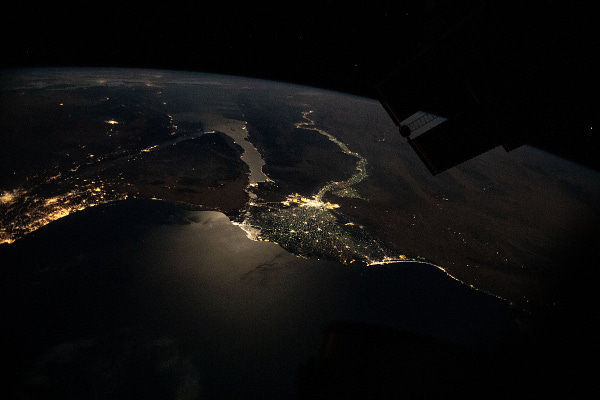 This nighttime photograph, taken from the International Space Station as it orbited 263 miles above Turkey, highlights the Moon's glint on the Mediterranean Sea and the Gulf of Suez. The city lights along the Nile Delta and the eastern Mediterranean coast also figure prominently in the picture.
