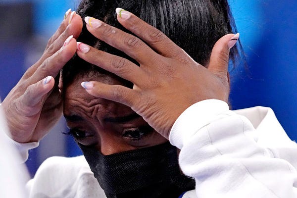An upset Simone Biles is seen after withdrawing from the women's gymnastic team finals at the Tokyo Olympics.
