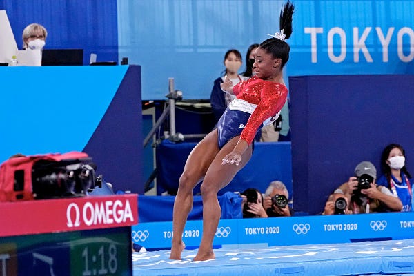 Simone Biles lands awkwardly while competing on the vault.