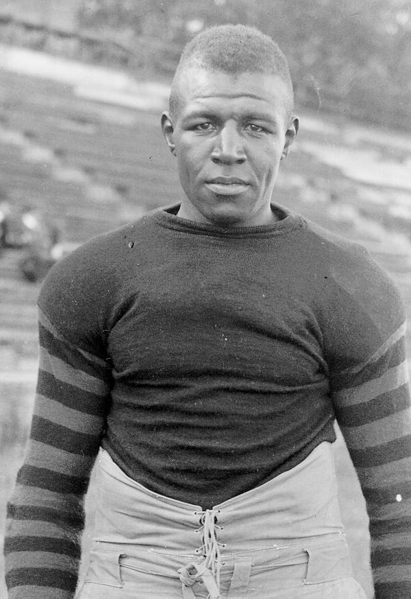 Duke Slater poses for a portrait wearing his football gear.