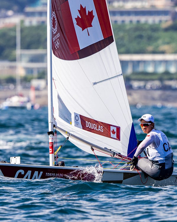 A wide shot of Sarah Douglas on her boat in the water during the race.