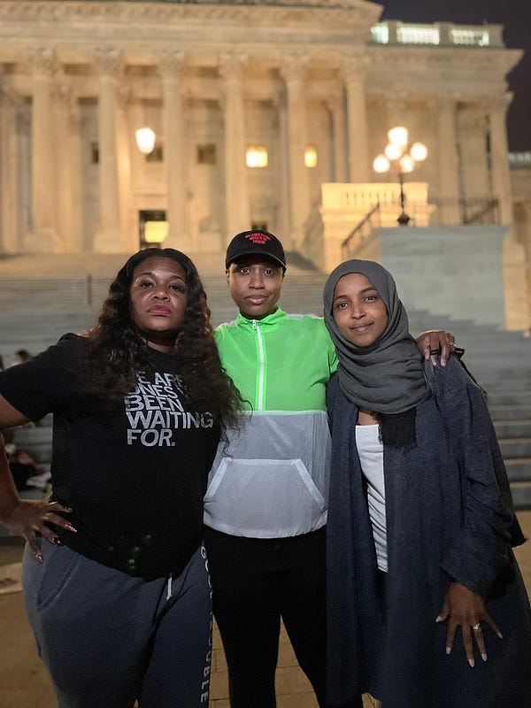 Cori Bush, Ayanna Pressley, and Ilhan Omar pose for a picture in front of the Capitol