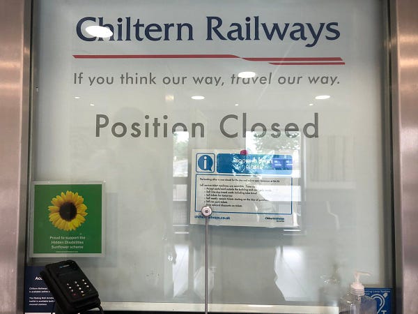 A customer service desk which is closed - it has a blind pulled down which reads “position closed” and “Chiltern Railways: if you think our way, travel our way”. There is a laminated sign up which reads ‘booking office closed’ with some more information’.