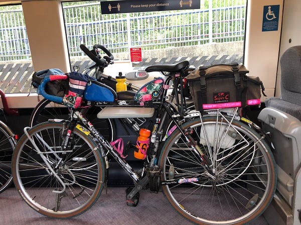 On the train, there are several bikes all stashed up together in the wheelchair priority space, blocking the space.