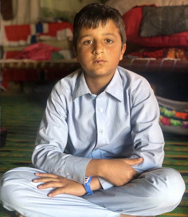 When his family found Khanzada under the rubble, they were hopeful that his grandparents survived too. An hour later, they found the bodies. #PrecisionStrike

A boy named Khanzada, sitting with his arms and legs crossed in a blue shalwar kurta. 
