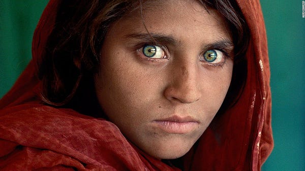 Famous 1985 National Geographic Afghan Girl photo, adolescent girl with piercing green eyes wearing red headscarf
