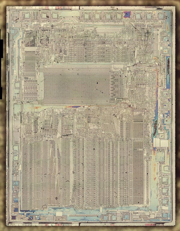 Die photo of the 8087 coprocessor with the metal layer stripped off to reveal the silicon underneath. Patterns are visible in the silicon, the transistors that implement the circuitry,