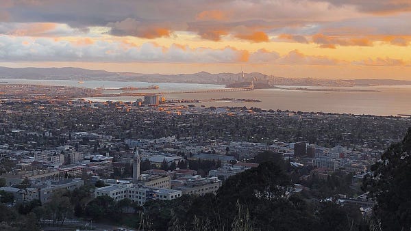 Overhead shot of the SF skyline, bay, and Berkeley campus at sunset.
