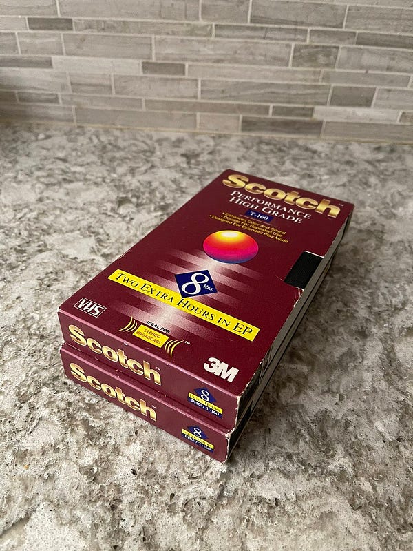 Did you think I was talking about a tasty drink??? On the countertop: a pair of Scotch-brand VHS tapes from 1995 (yes, really - labeled as such!). Found them in an old box of random items. These are “Performance High Grade T-160 tapes, according to the maroon-color boxes, with a gigantic “8 HOURS” in the middle, along with “TWO EXTRA HOURS IN EP” underneath. Of course, recording in EP looked horrible, so these are recorded in SP (2 hours, 40 minutes).