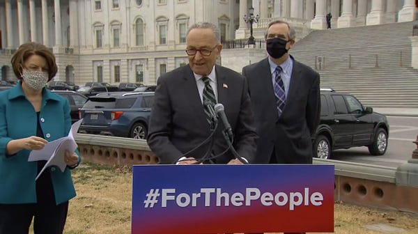 A photo of Senators Schumer, Merkley, and Klobuchar speaking about the Senate introduction of the For the People Act.