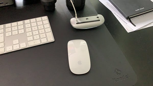 Picture of a Magic Mouse charging with another Magic Mouse next to it