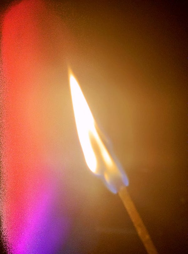 A close-up of the flame of a lit match