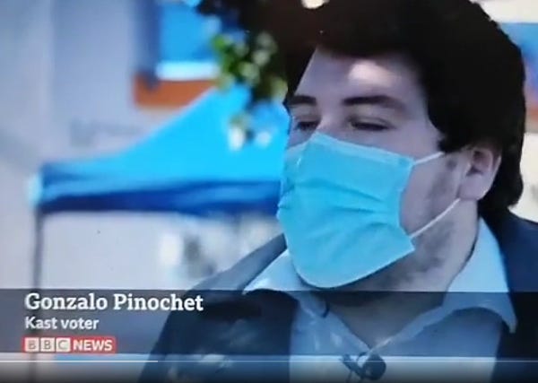 A BBC News interview chyron showing a neck rated Chilean man with a face mask against a background of an outdoor tent but his name is “Gonzalo Pinochet”. Pinochet being the name of the notorious fascist dictator who ruled Chile from 1973 to 1981.
