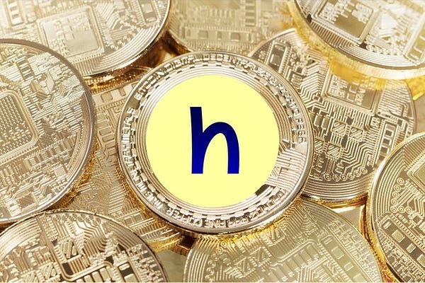 The hopr logo on top of metal cryptocurrencies