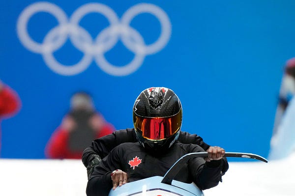 Canadian bobsled waiting to start race at top of track.
