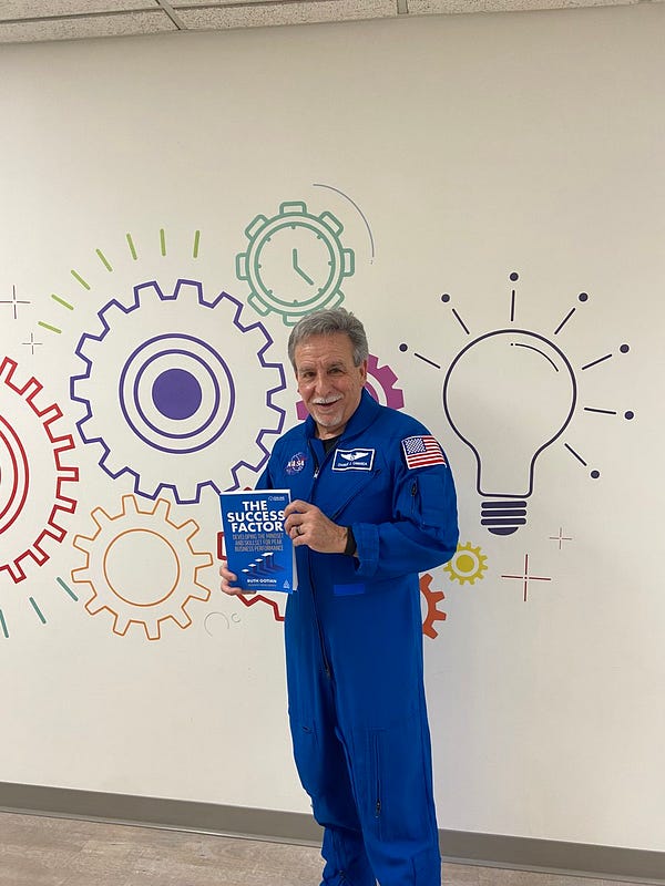 Astronaut Dr. Charles Camarda with the book, The Success Factor, which he is featured in.