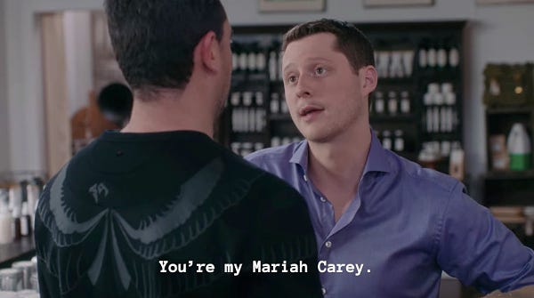 Schitt’s Creek Singles Week. David and Patrick in Rose Apothecary. Patrick Brewer to David Rose captioned “You're my Mariah Carey.” David wincing in response.