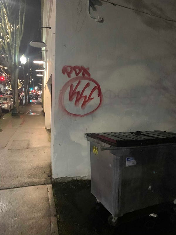 A wall in Olympia tagged “pdx” with a red iron front under it