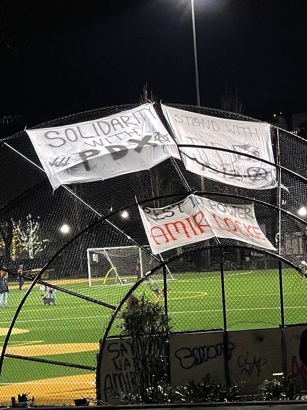 Banners hung up at cal park that says “solidarity with pdx” and “rest in power Amir Locke” and “stand with pdx 1312”