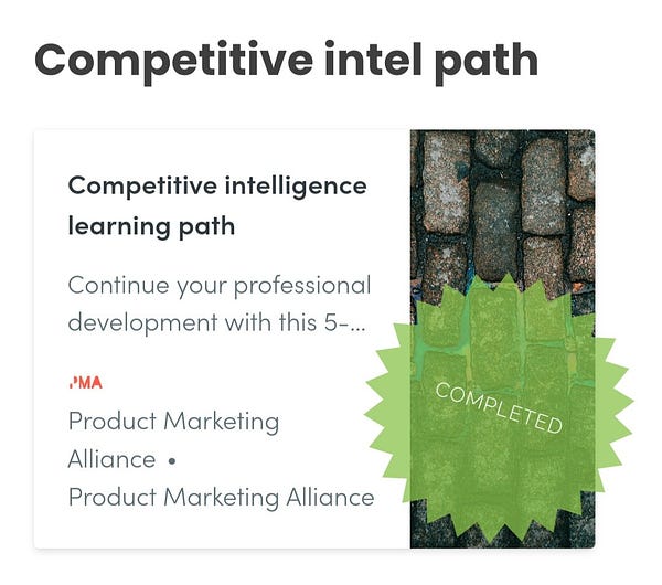 Image with copy: "Competitive intelligence learning path. Continue your professional development with this 5-..." PMA logo at bottom next to "Product Marketing Alliance" name. Right side has a stock image of cobblestones, overlain with a green translucent starburst-shaped "sticker" with the word COMPLETED on it.