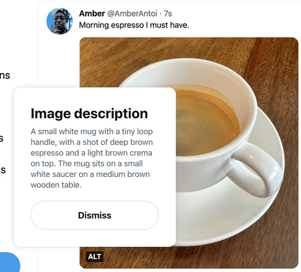 Screenshot of a published Tweet with an image of a cup of espresso. The exposed image description appears above the ALT badge and says: A small white mug with a tiny loop handle, with a shot of deep brown espresso and a light brown crema on top. The mug sits on a small white saucer on a medium brown wooden table.