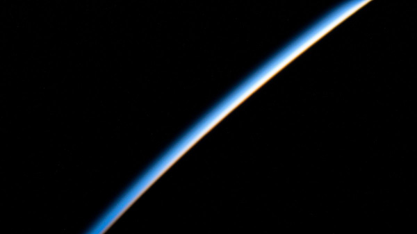 iss066e152097 (Feb. 22, 2022) --- The first rays of an orbital sunrise illuminate the Earth's atmosphere in this photograph from the International Space Station as it orbited 262 above the Pacific Ocean south of Russia's Kamchatka Peninsula.