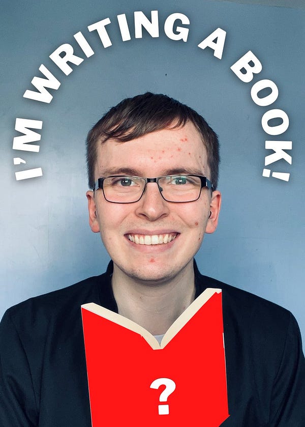 Liam - white man with short brown hair, glasses and a black jacket - smiles directly at the camera with a blue wall behind him. He’s holding up a book, edited to now have a red cover with a white question mark. Curved text above him reads: ‘I’m writing a book!’