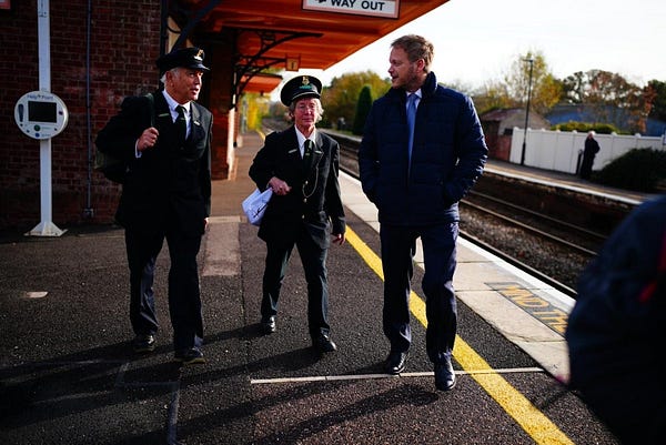 Station staff on a platform on the Dartmoor Line.