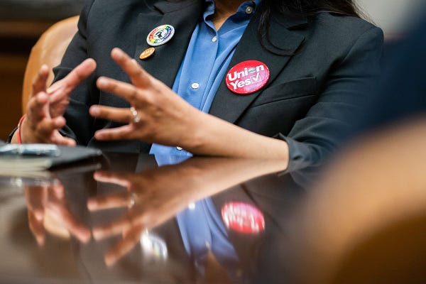 A photo of a ‘Union Yes’ button on Laura Garza, a Starbucks worker, who organized with SEIU.
