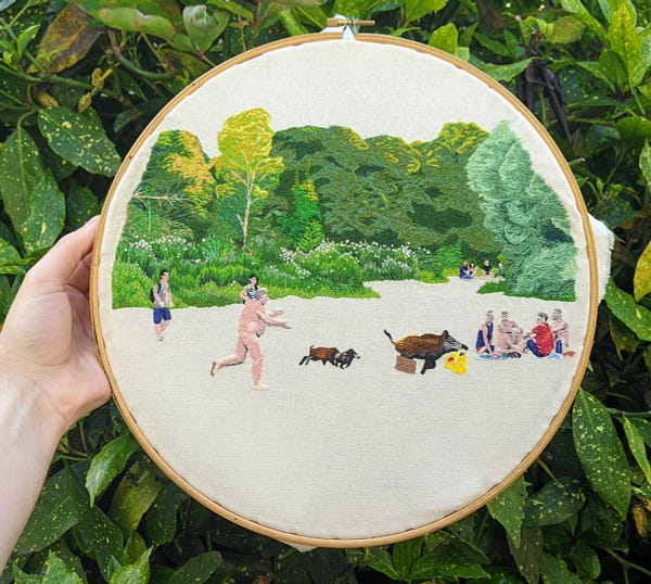 The previous photo of the naked man chasing a boar through a park, but embroidered by hand in fine detail onto fabric.