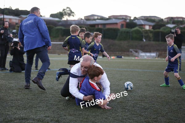 Scott Morrison tackling a child. Morrison is labelled "Me" and the child is labelled "Friday beers." 