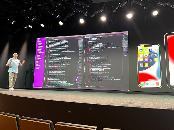 A super wide screen showing Xcode, iPhone, and iPad side by side.