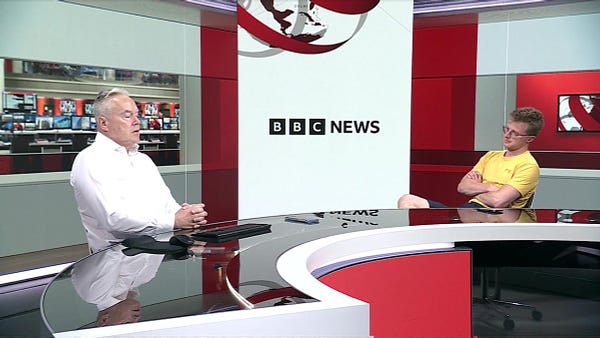 Scott Bryan on the right, wearing shorts, in the new BBC News studio.