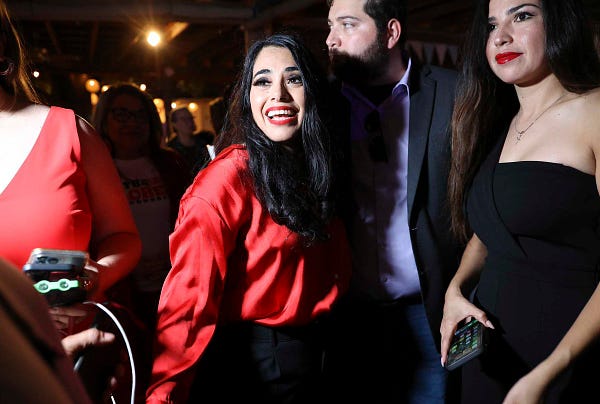 Republican Mayra Flores (center) reacts as she declares victory over her opponents for Congress in Texas District 34 as supporters cheer her on at her watch party in San Benito on Tuesday, June 14, 2022.