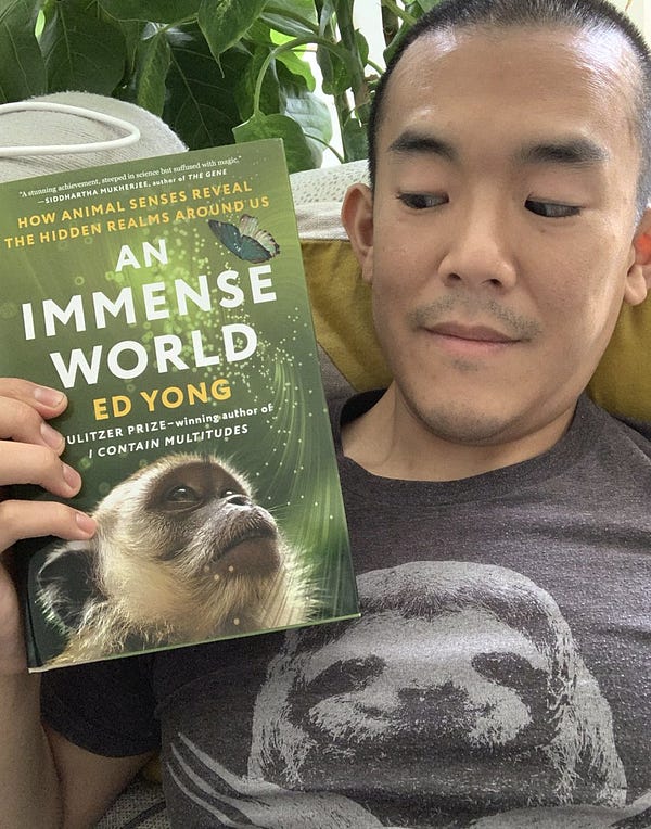 A giant doofus holding up a copy of his book and staring at the monkey on the cover. 