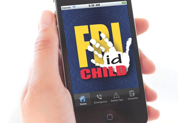 A person holding a cell phone showing the FBI Child ID app on screen. First released in August 2011, the mobile application provides a convenient place to electronically store photos and vital information about children so that it’s literally right at hand if needed. 