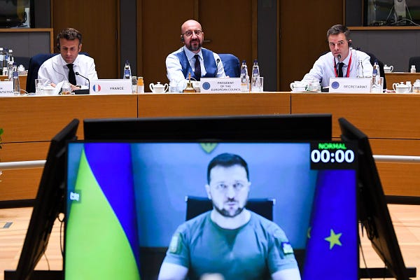 From left to right: French President Emmanuel Macron, President of the European Council Charles Michel and Prime Minister of Spain Pedro Sánchez Pérez-Castejón with Ukrainian President Zelenskyy joining via video, at the European Council meeting in Brussels.