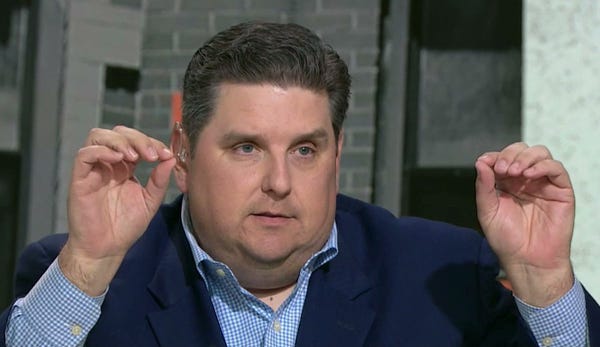 Brian Windhorst with his hands up like he's holding a little banner