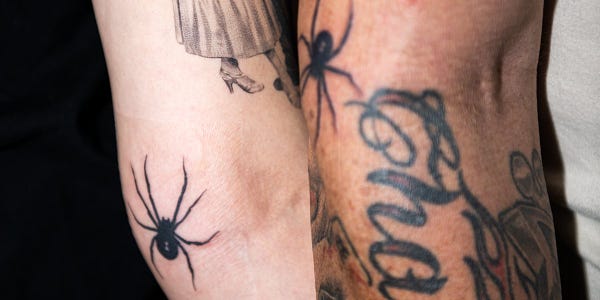 Photo of two matching spider tattoos.