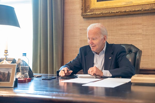 President Biden works at his desk.