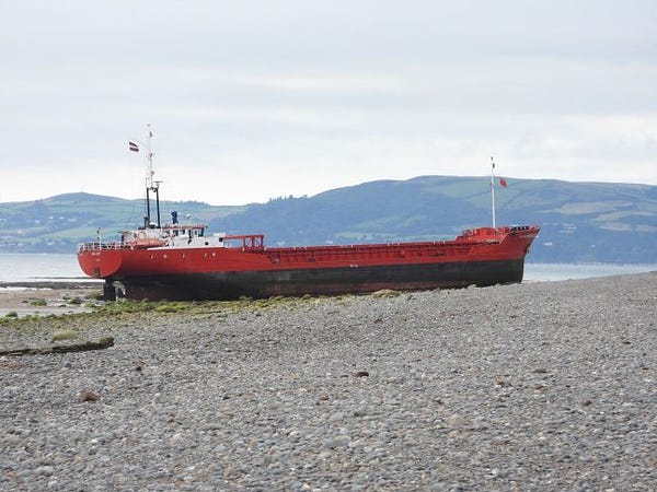 A smallish - these things are of course relative, and it's 64m long - cargo ship stranded on a shingle beach. It's very much high, and regrettably dry. 