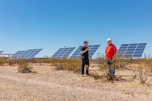 Mark Kelly speaks with a man about solar panels. 