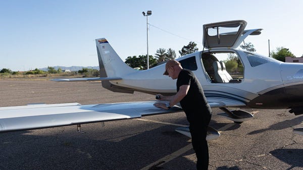 Mark Kelly runs pre-flight checks before flying to meet with Arizonans.