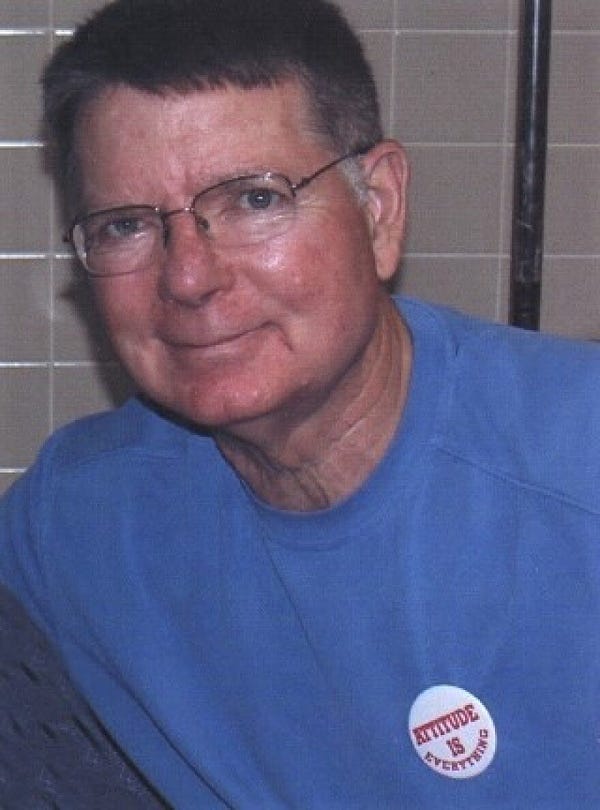 Middle aged white man in glasses, smiling 
