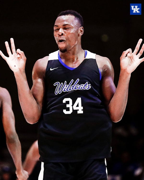 Oscar Tshiebwe celebrates after another Antonio Reeves three-pointer.