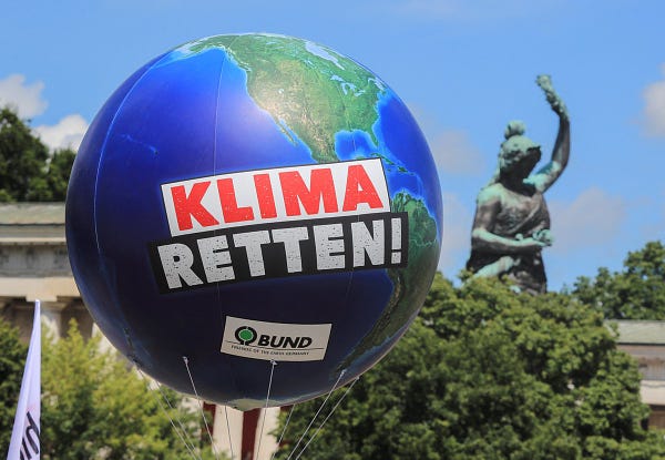 A balloon globe with the inscription "Save climate!" in German.