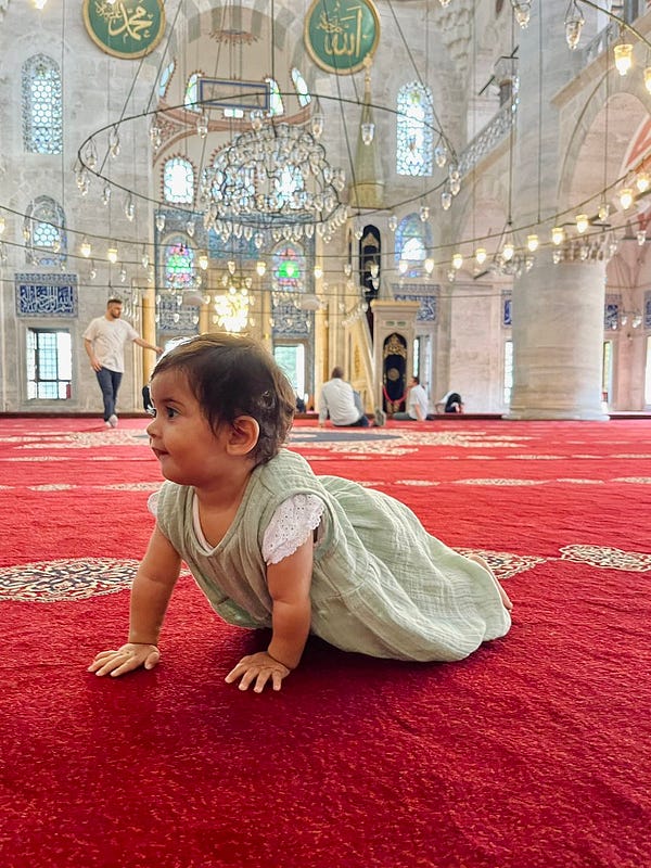 An inspired baby crawling on masjid carpet surrounded by an atmosphere crafted, and used for generations, by hearts who care.