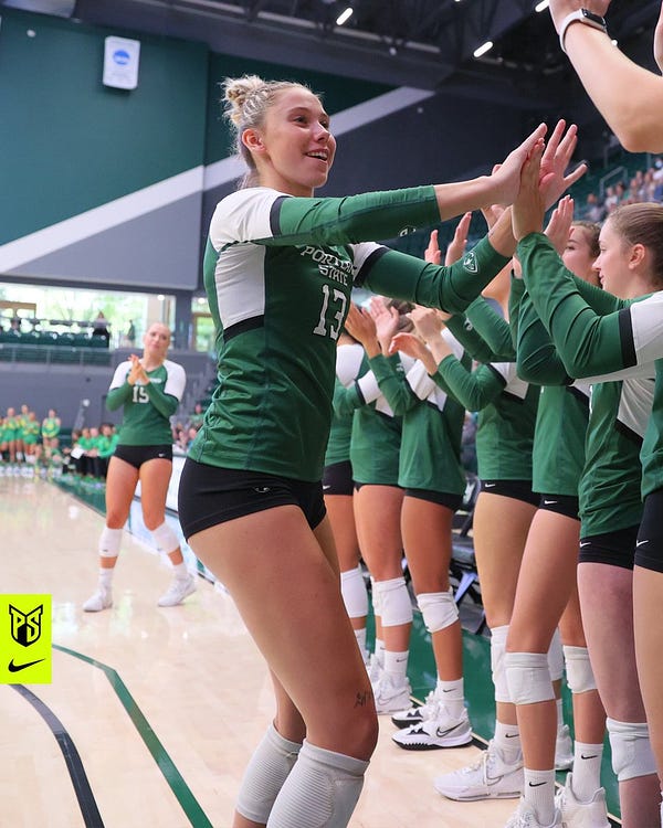 Portland State volleyball player Sophia Meyers high-fives her teammates as she's announced as a starter before a match.