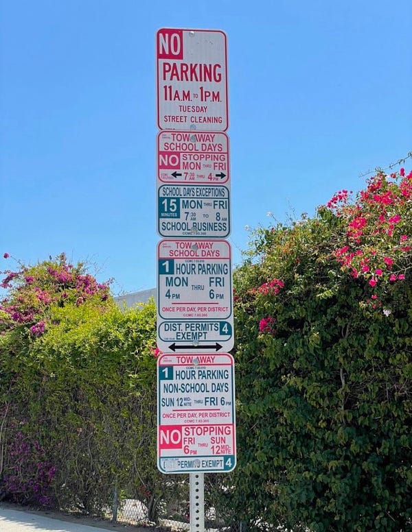 A very large, very confusing combination of street parking signs.