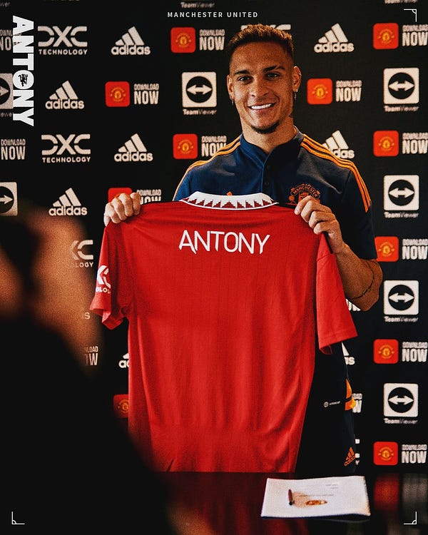 Antony holds up a United home shirt with his name printed on the back.